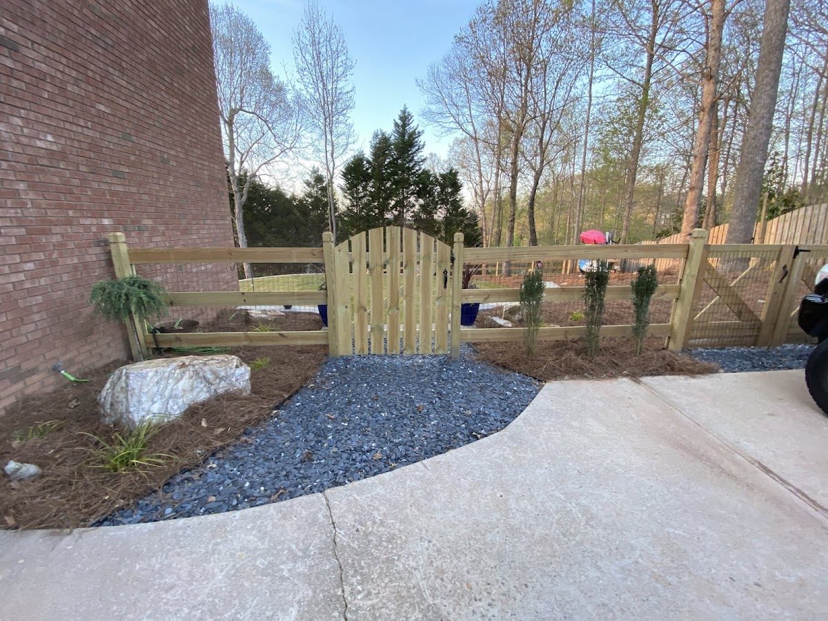 Wood fence and gate by a gravel path